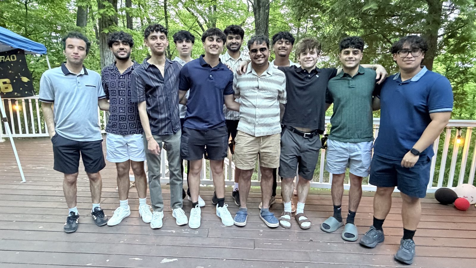 Friends standing together on an outdoor deck