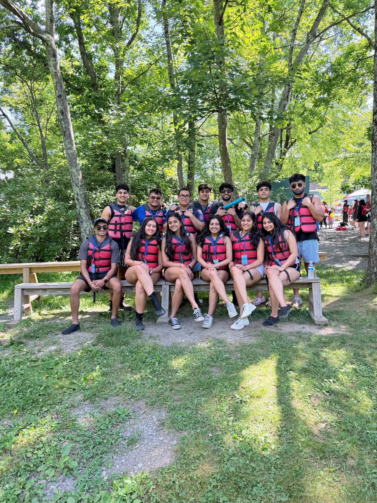 Group at an outdoor community event wearing life jackets