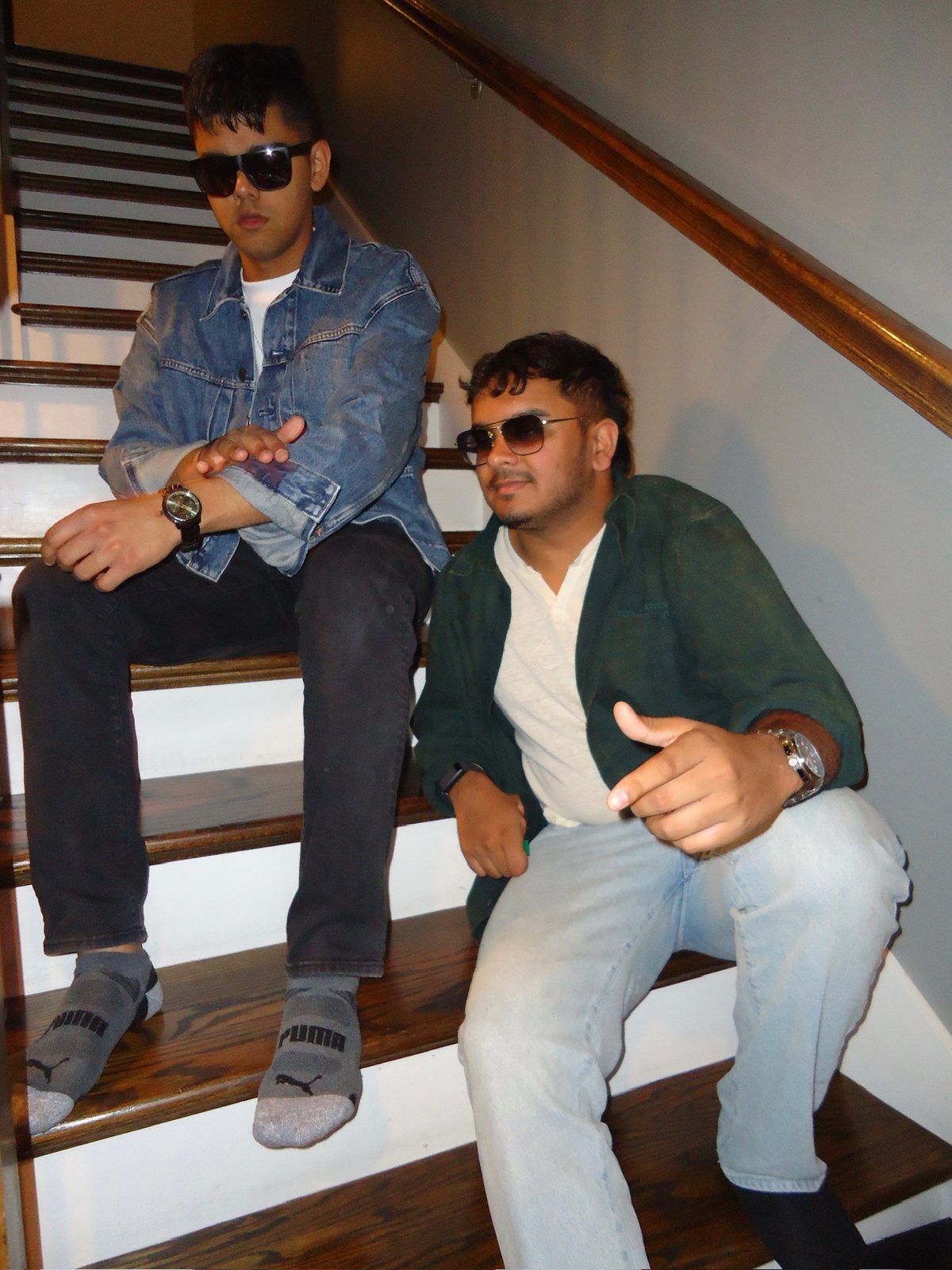 Preet Desai with a friend sitting on indoor stairs